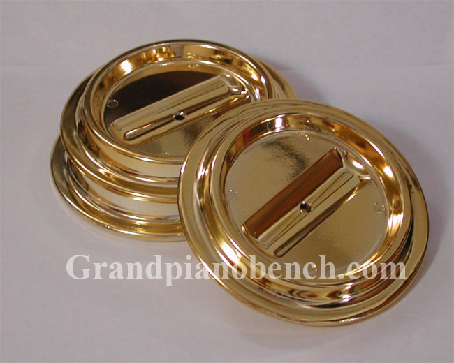 three brass piano caster cups